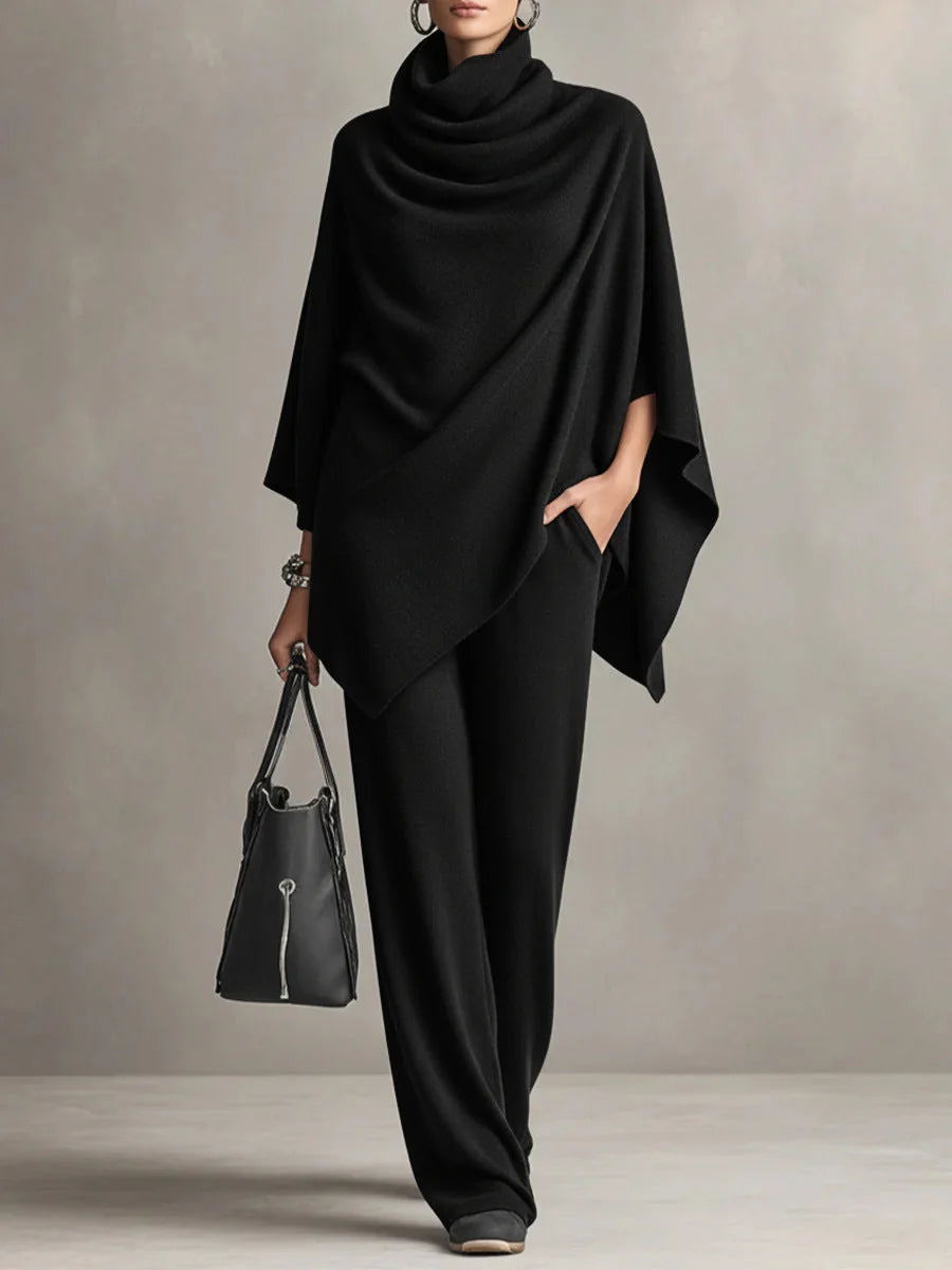 Woman wearing black cowl neck two-piece set with wide-leg trousers and draped top