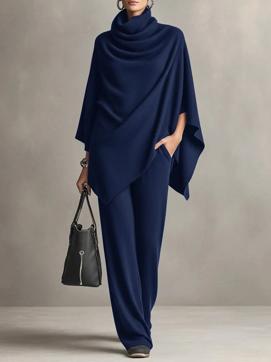 Side view of women's black draped top with kimono sleeves and matching trousers