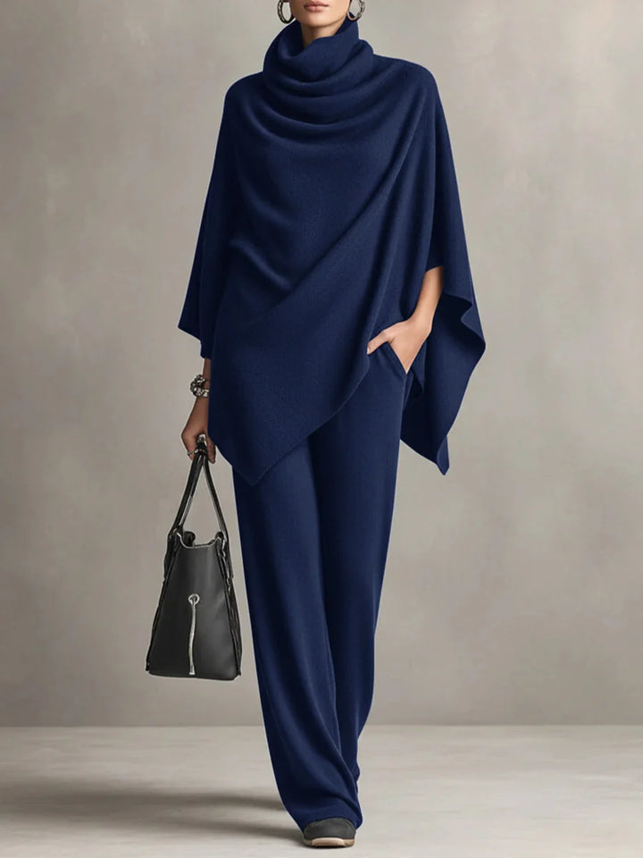 Side view of women's black draped top with kimono sleeves and matching trousers