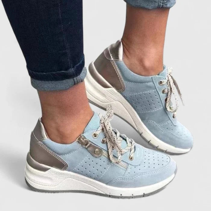 Side view of women's orthopaedic trainers displaying chunky platform sole and supportive arch structure.