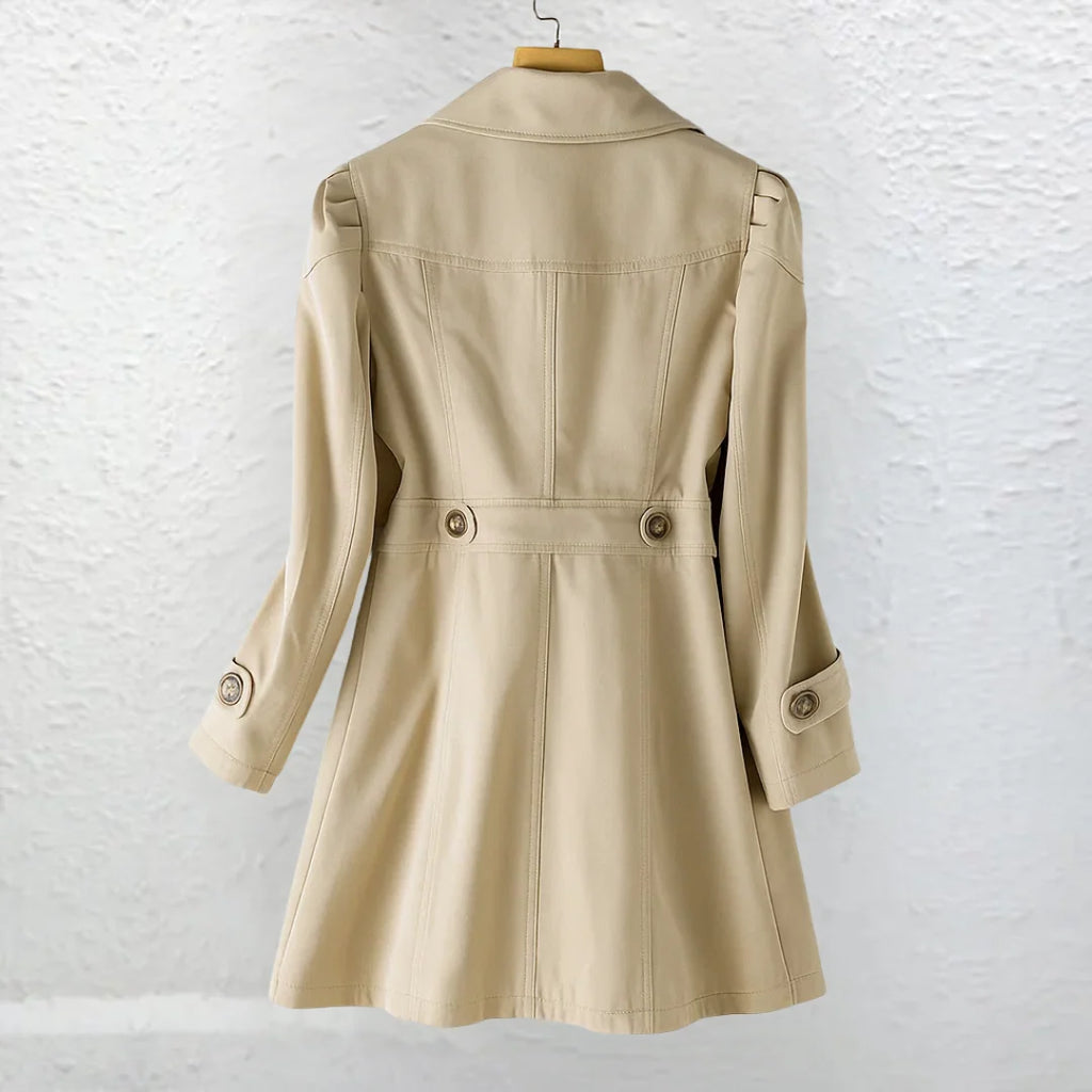 Back view of women's trench coat in beige with tailored waist and button details