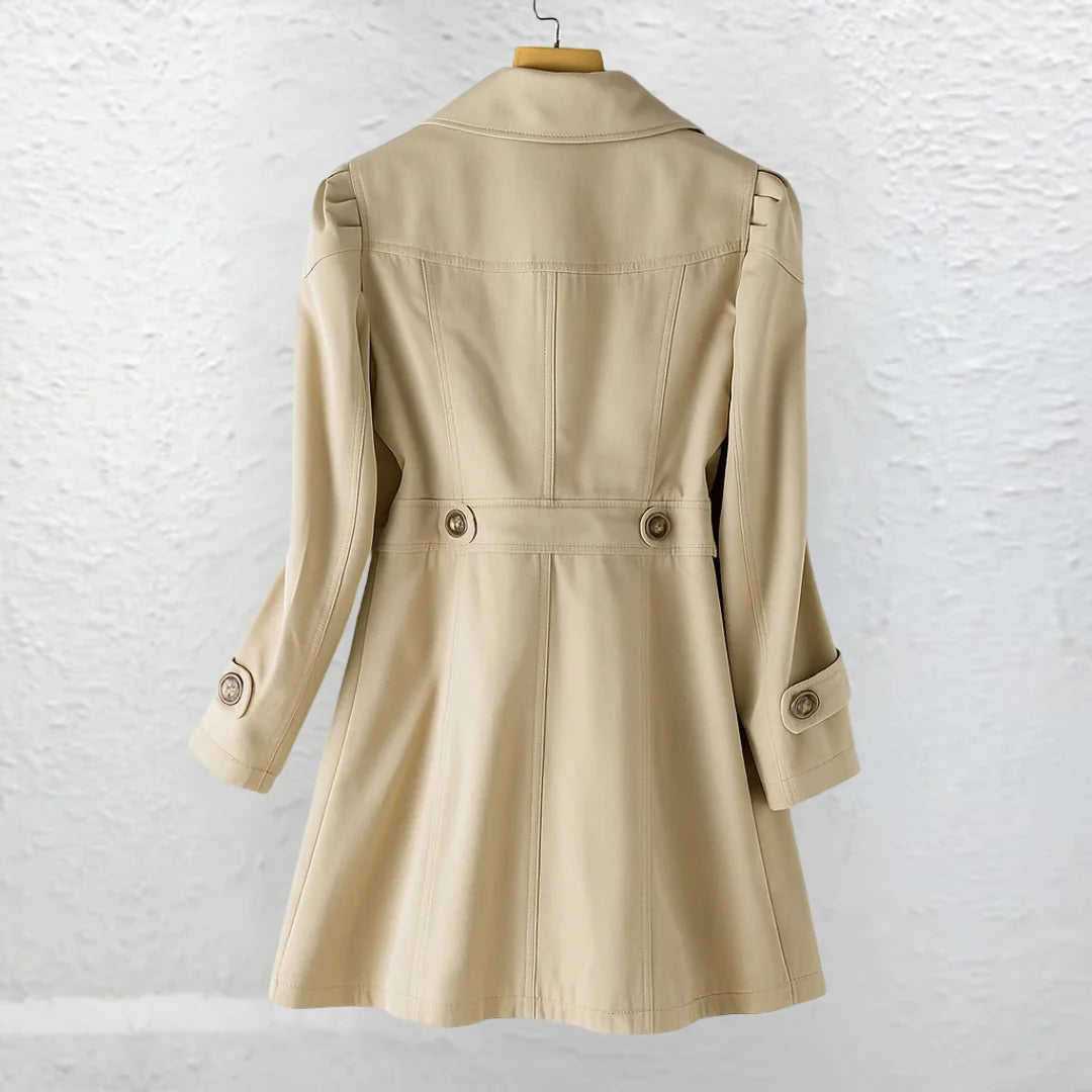 Back view of women's trench coat in beige with tailored waist and button details