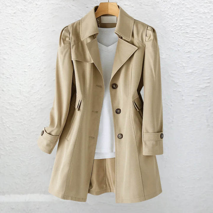 Side view of women's trench coat with side pockets and mid-thigh length