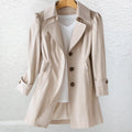 Front view of tailored trench coat in beige with double-breasted styling