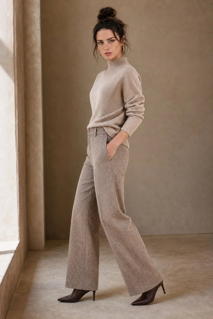 Close-up of women's wool trousers showing tailored straight-leg silhouette and structured woven fabric