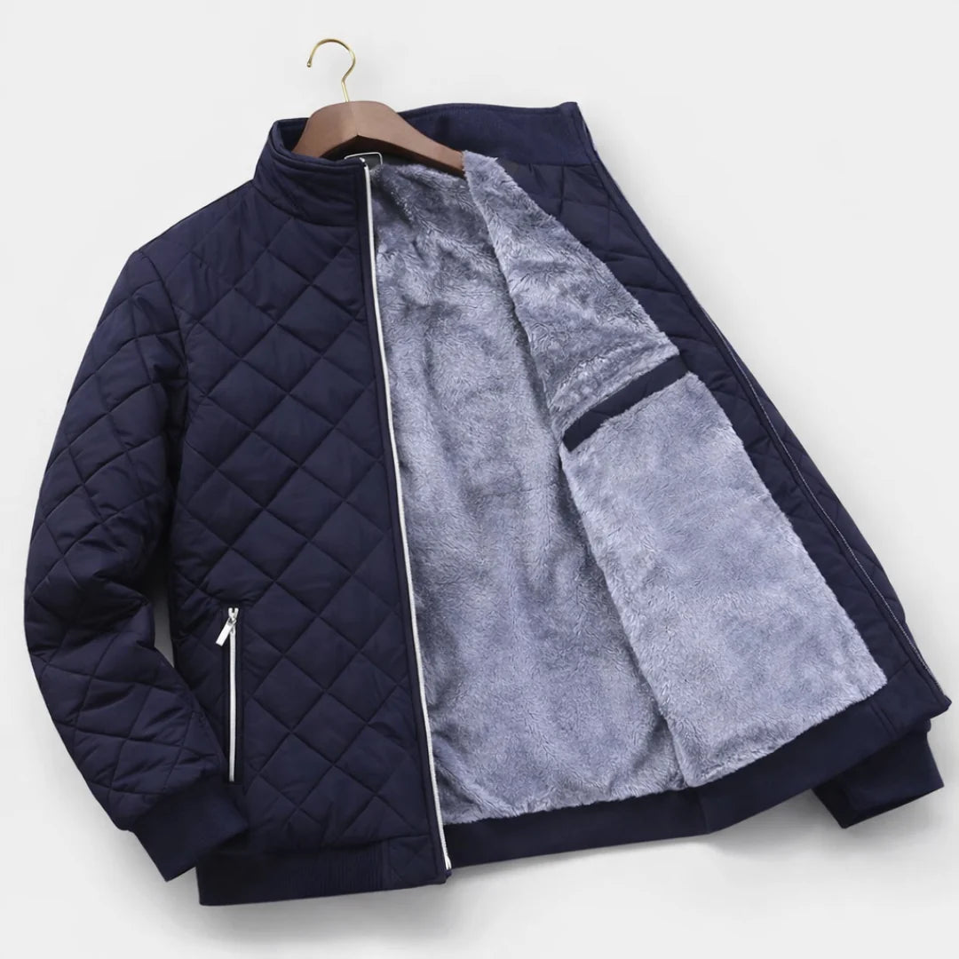Men's quilted bomber jacket styled with black turtleneck and dark denim jeans