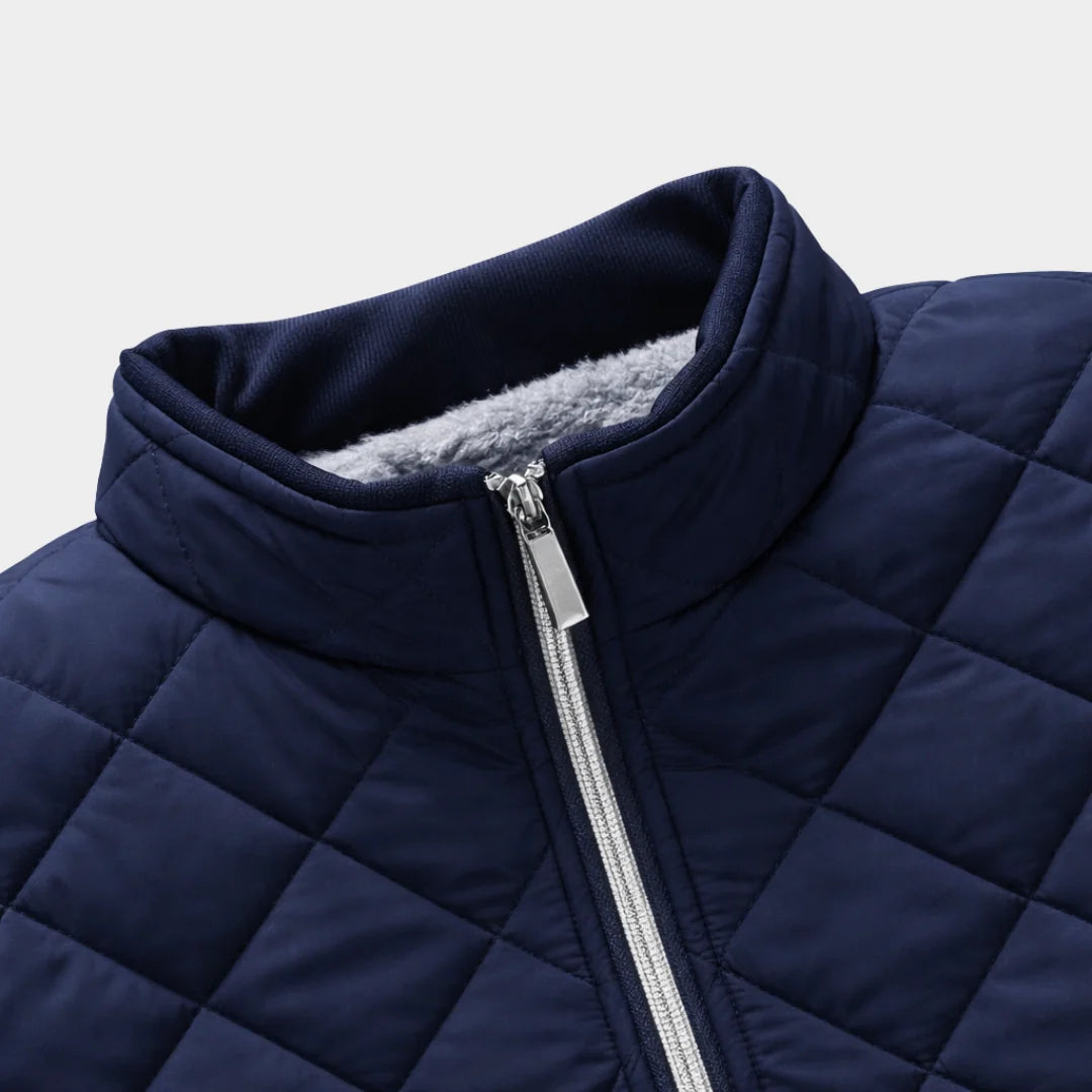 Back view of navy quilted bomber jacket with structured shoulders and hem