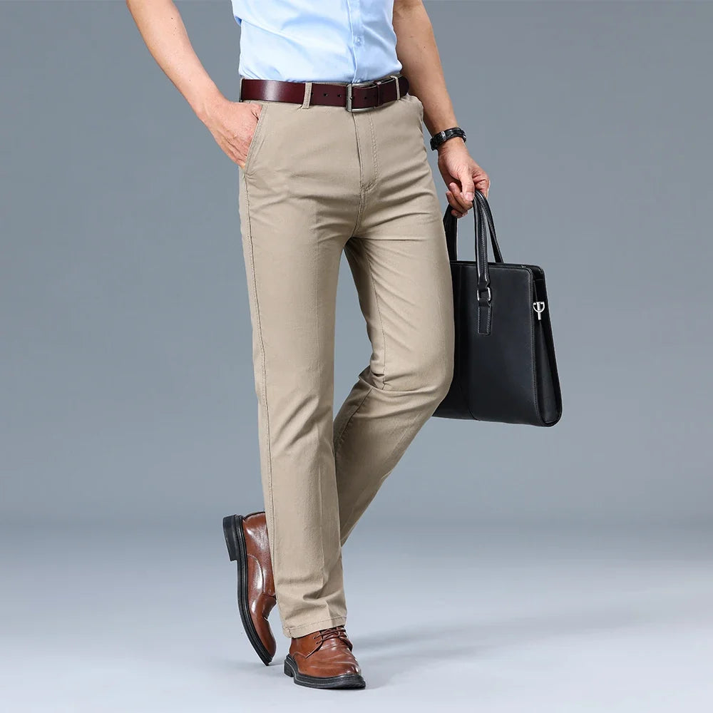Detail view of men's slim fit dress trousers showing fabric drape and tailored construction
