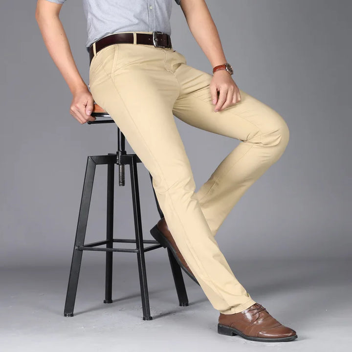 Side view of men's slim fit trousers in khaki with streamlined cut and polished finish