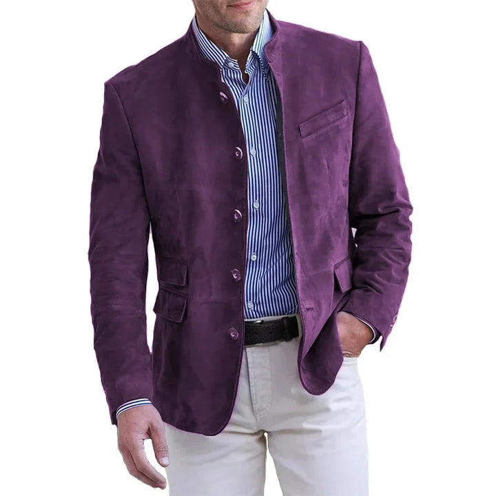 Men's tan blazer with band collar styled with white trousers for smart-casual occasion