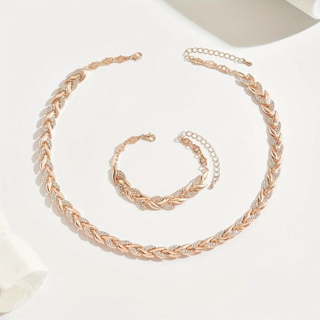Overhead view of rhinestone chain necklace and bracelet set showing chevron link pattern