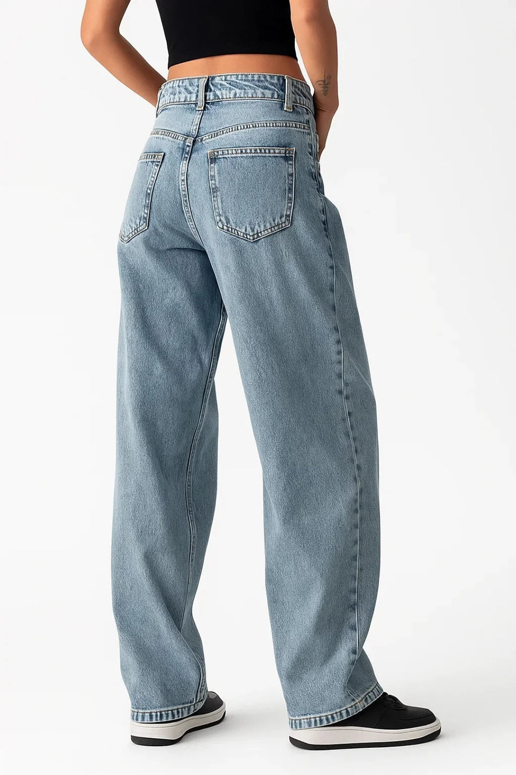Close-up view of women's baggy jeans showing relaxed silhouette and light blue wash finish