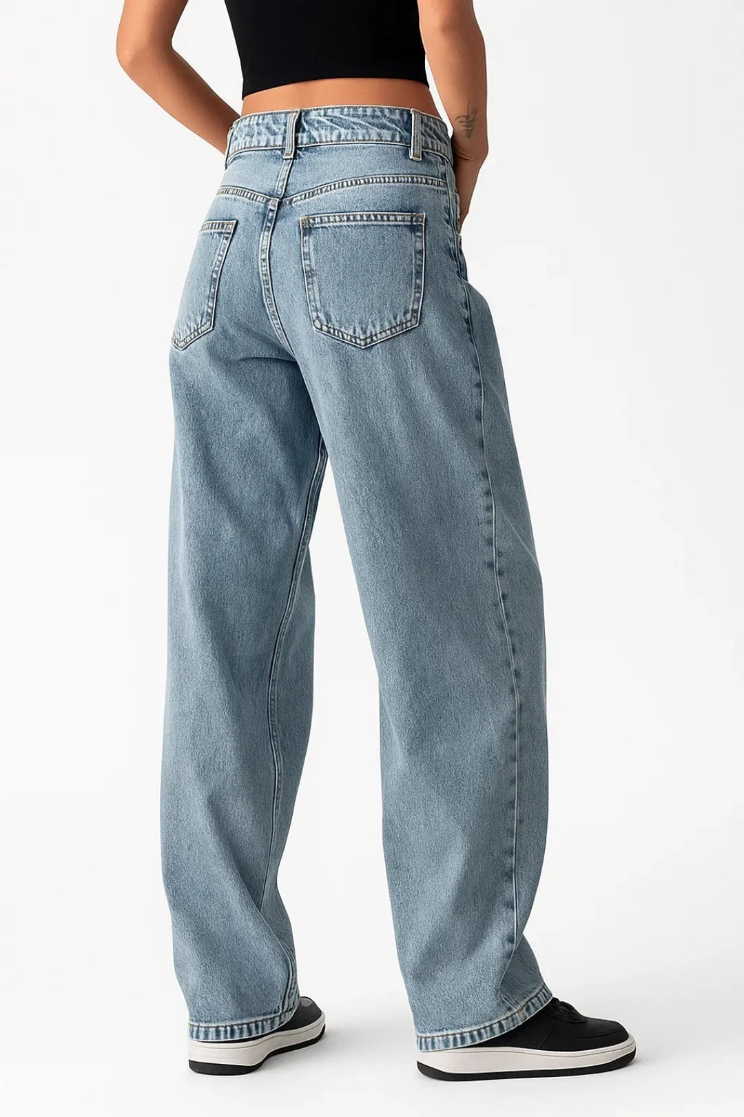 Close-up view of women's baggy jeans showing relaxed silhouette and light blue wash finish