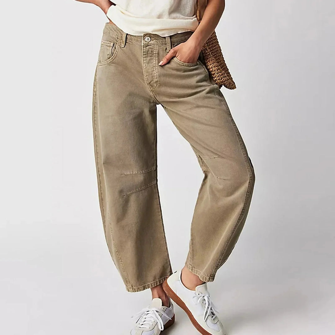 Detail shot of mid rise waistband and relaxed thigh fit on barrel leg jeans