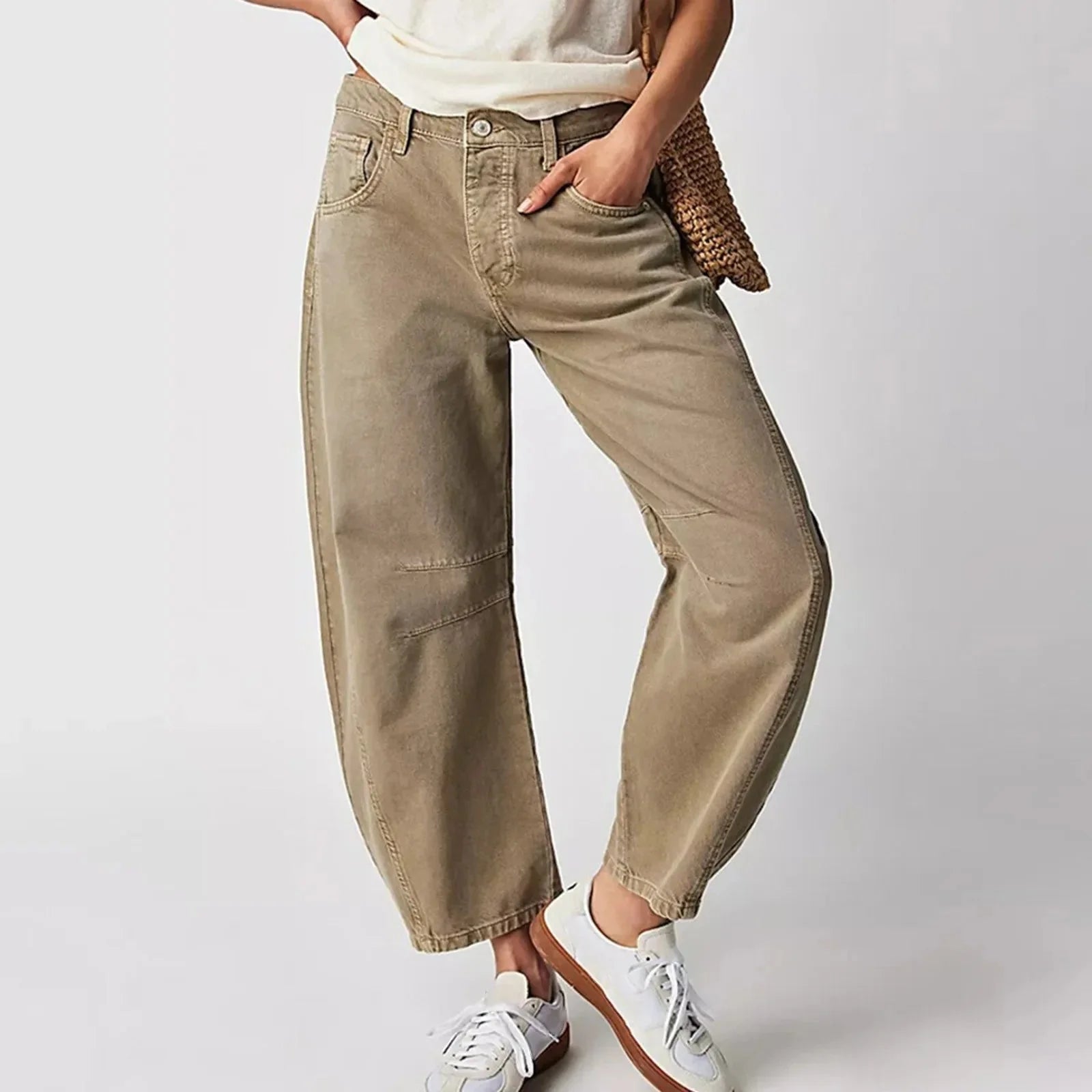 Detail shot of mid rise waistband and relaxed thigh fit on barrel leg jeans