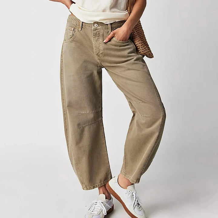 Detail shot of mid rise waistband and relaxed thigh fit on barrel leg jeans