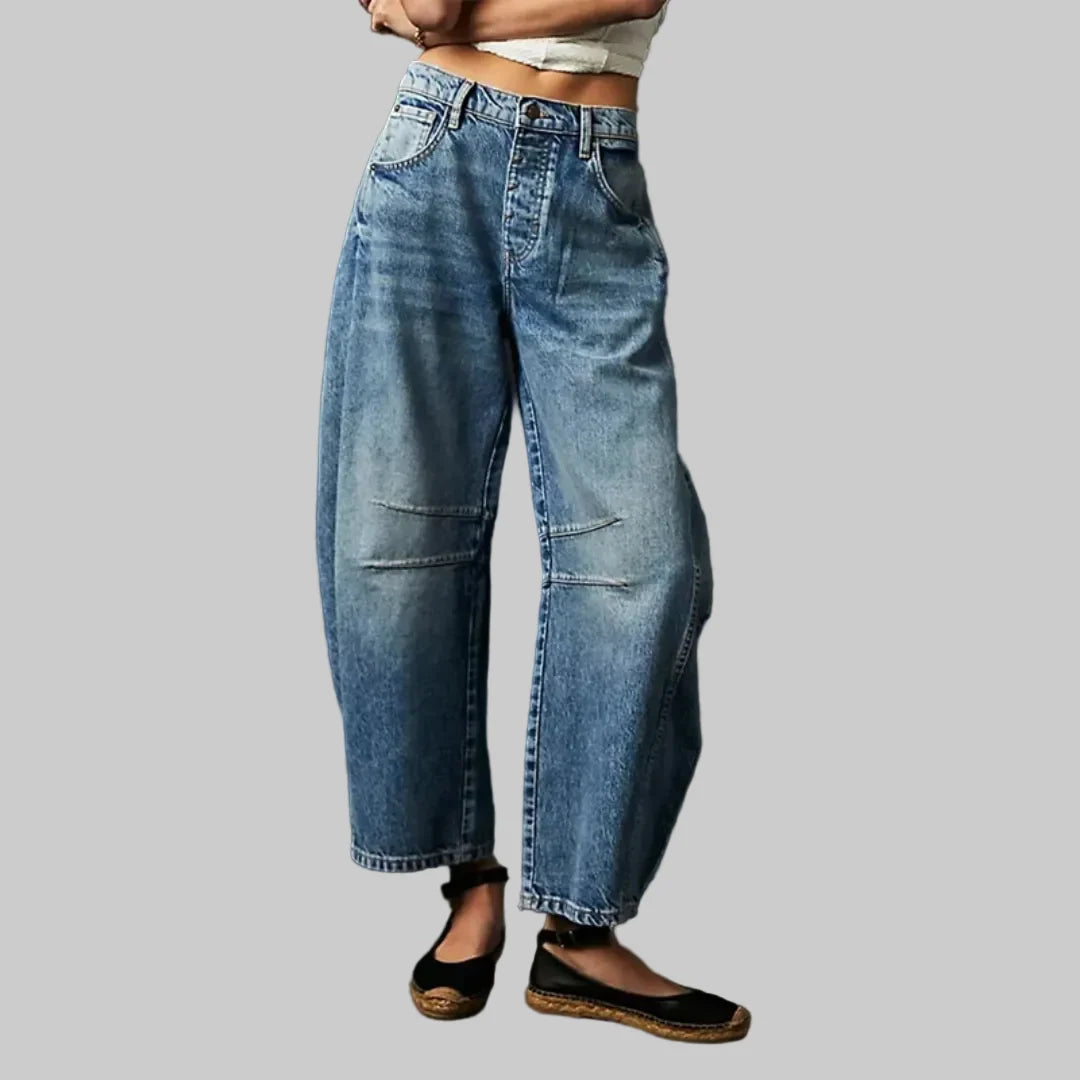 Women's barrel leg jeans styled with casual top showing comfortable mid rise and tapered ankle