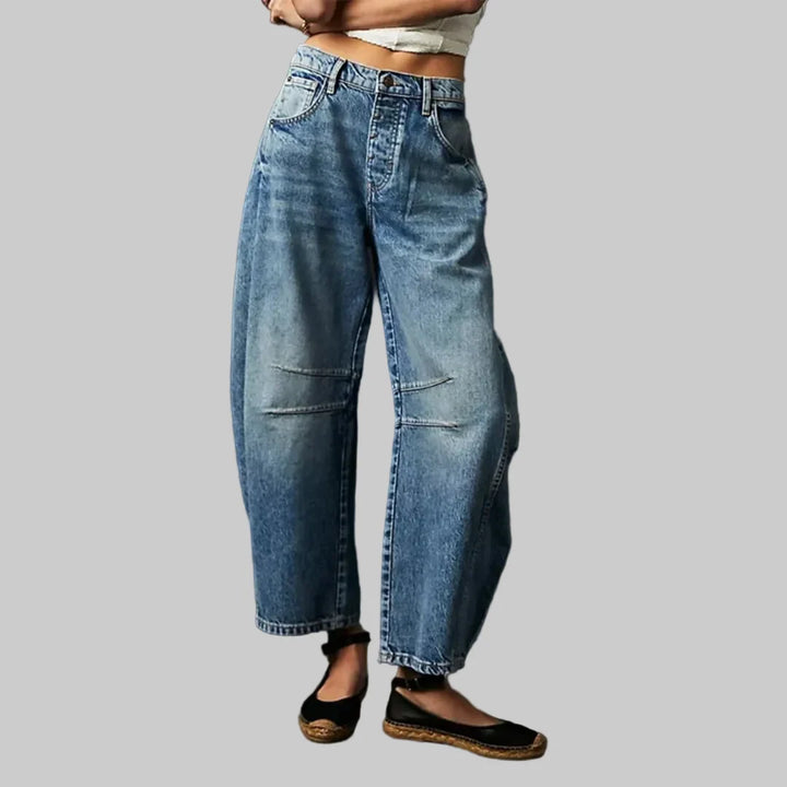 Women's barrel leg jeans styled with casual top showing comfortable mid rise and tapered ankle