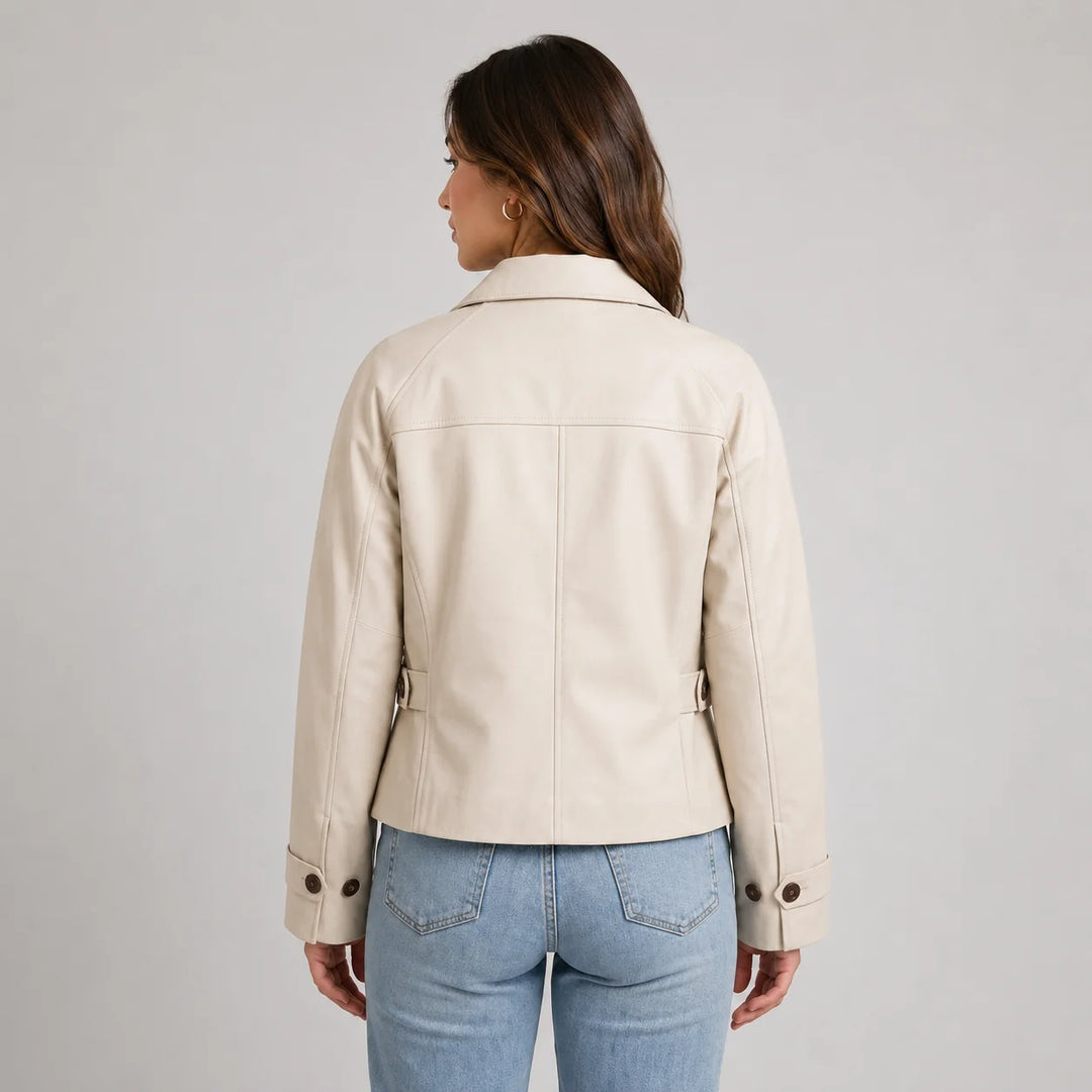 Close-up of cropped trench jacket showing adjustable sleeve tabs and button detail in beige