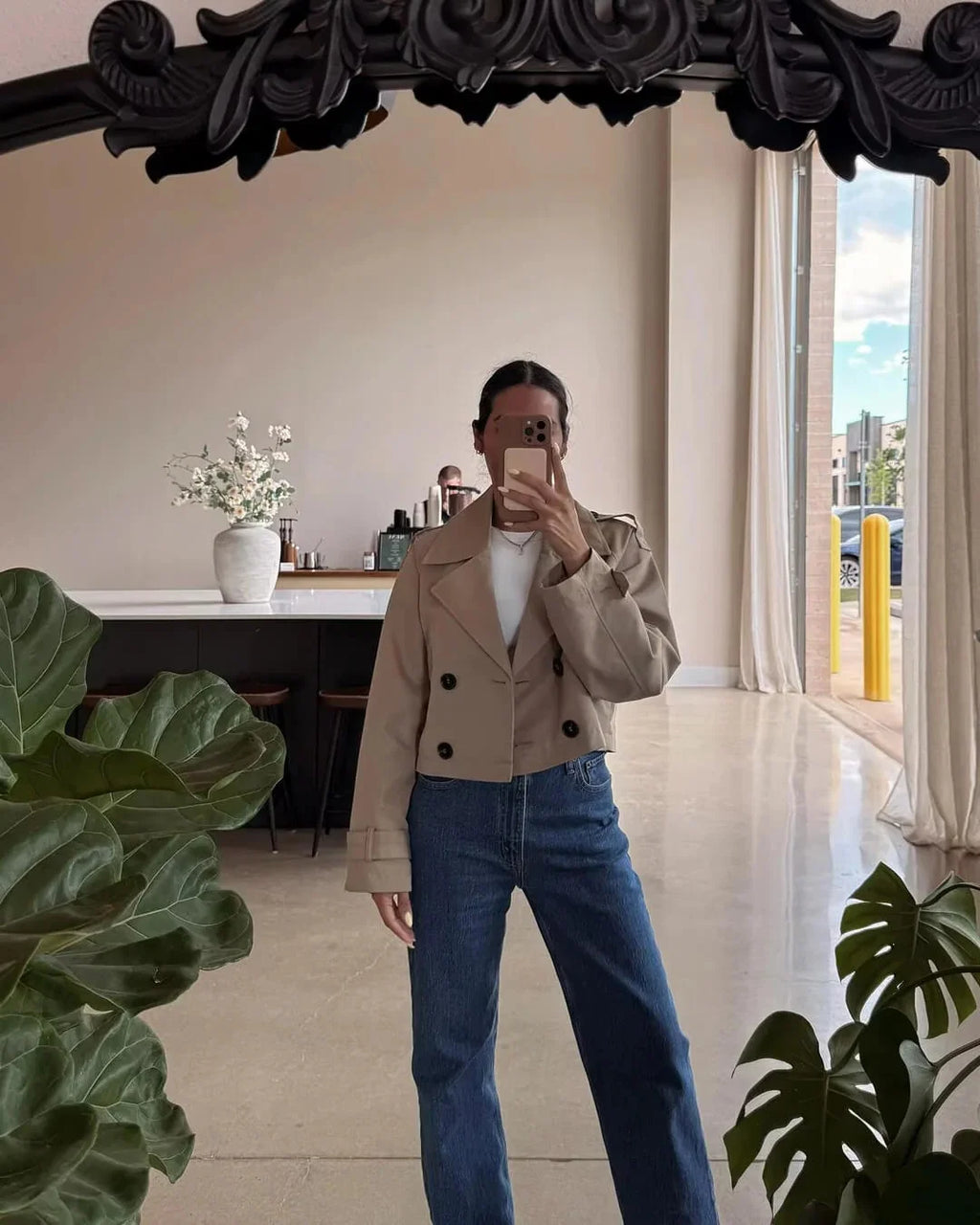 Front view of women's cropped trench jacket showing structured tailoring and mid-hip length