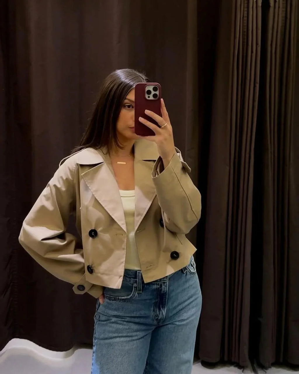 Back view of women's cropped trench jacket showing structured shoulders and tailored seams