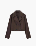 Women's cropped trench jacket styled over casual outfit for transitional weather