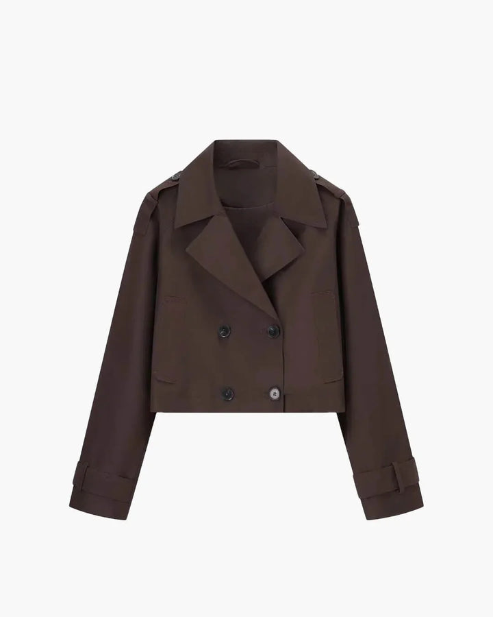 Women's cropped trench jacket styled over casual outfit for transitional weather