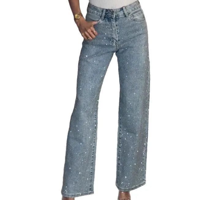 Detail shot of diamanté embellishments on light wash denim jeans with high waisted button closure