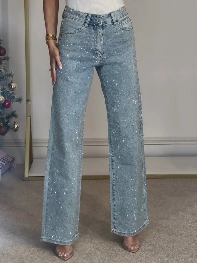 Model showcasing embellished wide leg jeans with flowing silhouette and sparkling diamanté finish
