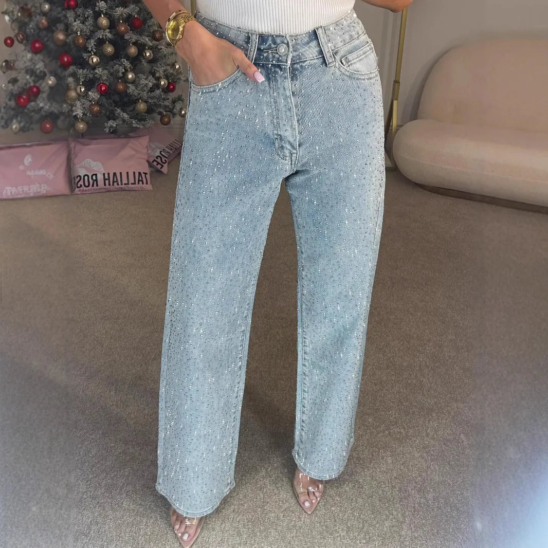Back view of high waisted embellished jeans showing wide leg cut and pocket detailing with diamantés