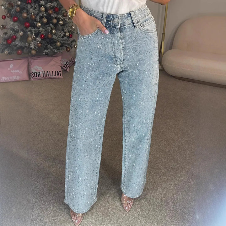 Back view of high waisted embellished jeans showing wide leg cut and pocket detailing with diamantés