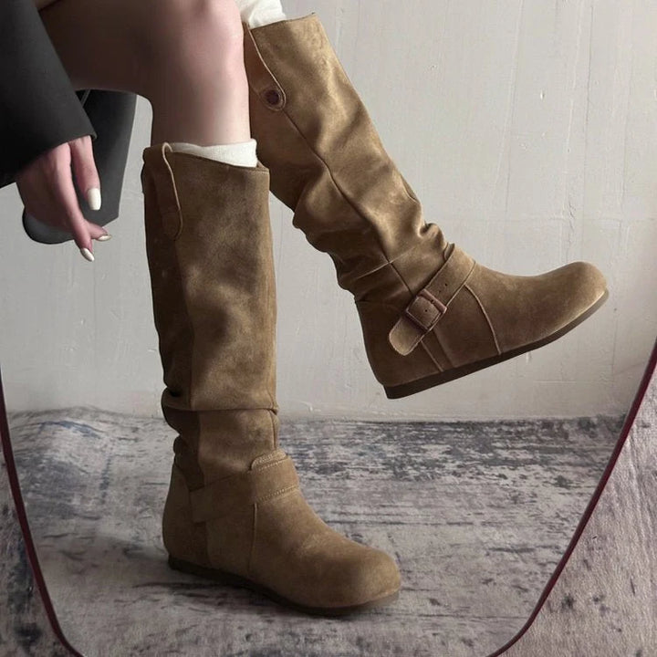 Side view of women's flat-sole slouch boots with relaxed shaft and pull-on tabs