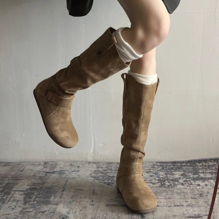 Detail of pull-on tab at back of knee-high slouch boot for easy entry