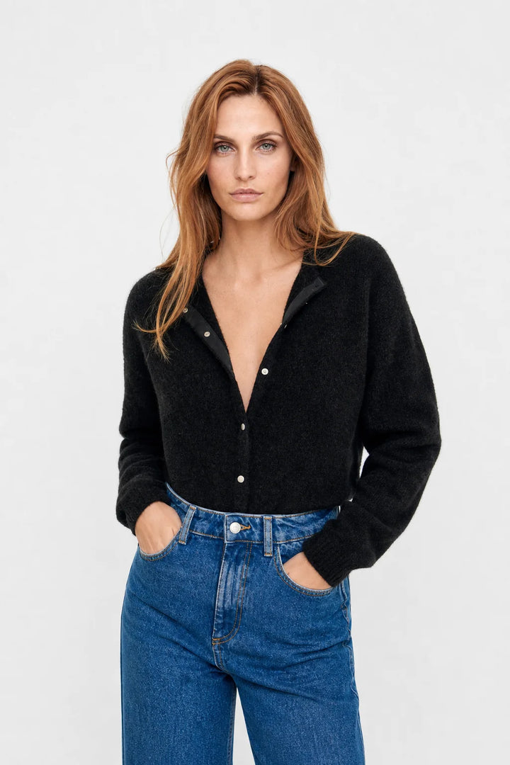 Woman styling navy mohair top cardigan with high-waist trousers for autumn layering