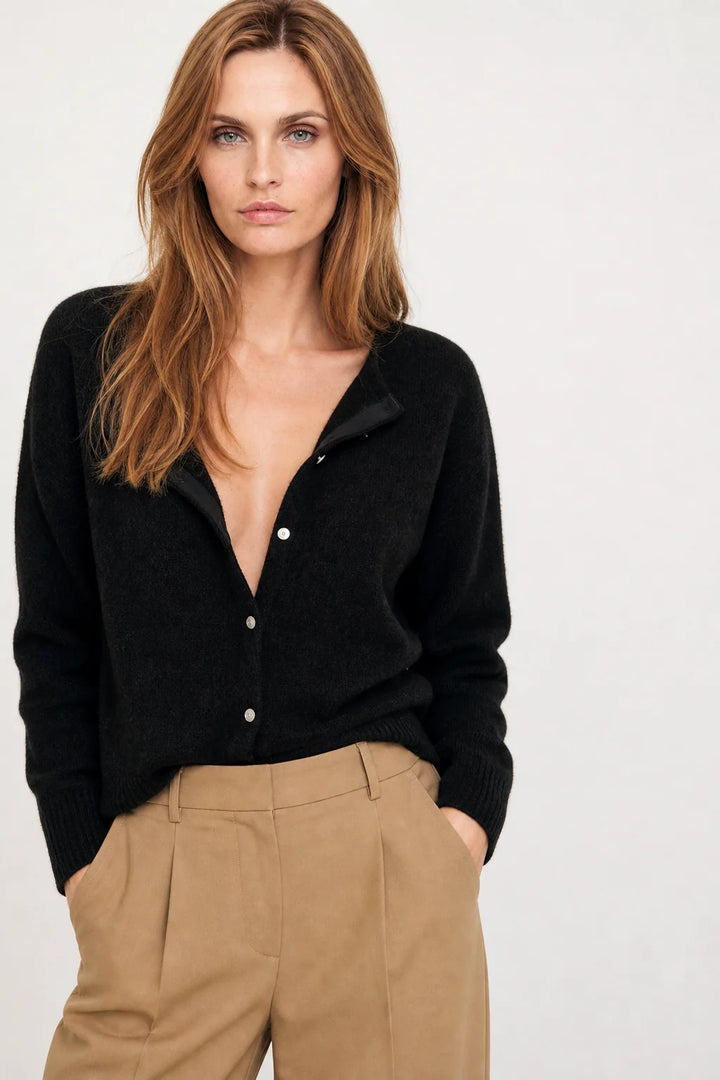 Close-up of V-neckline and first button on women's mohair top cardigan