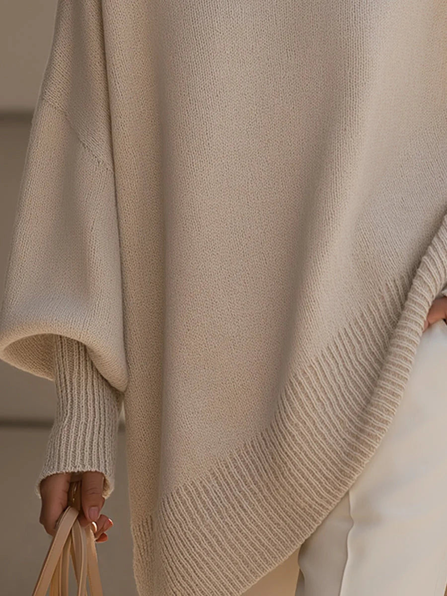 Oversized jumper styled with tailored trousers and sunglasses for contemporary look