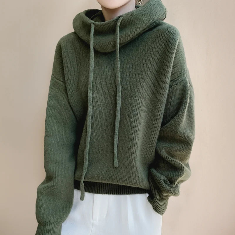 Close-up view of relaxed fit knit hoodie showing cowl neck drawstring and ribbed knit construction