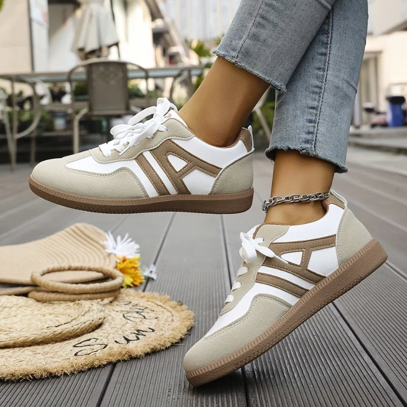 Side view of women's wide-toe trainers highlighting structured silhouette and neutral beige accents