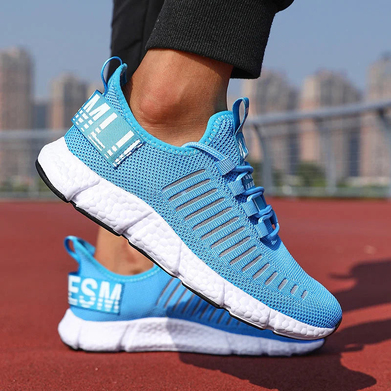 Men's knit trainers in sky blue with white cushioned sole and lace-up closure on outdoor track