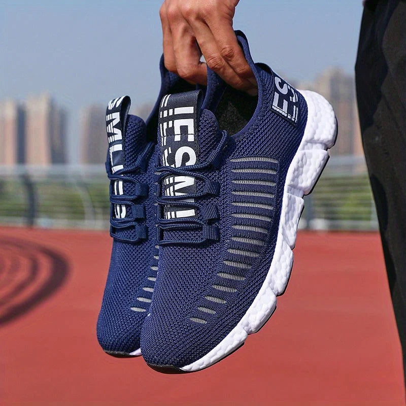 Men's knit trainers in sky blue worn outdoors showing lace-up design and ankle support