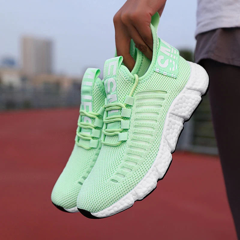 Men's knit trainers displaying lightweight design with supportive lace-up closure and pull tab