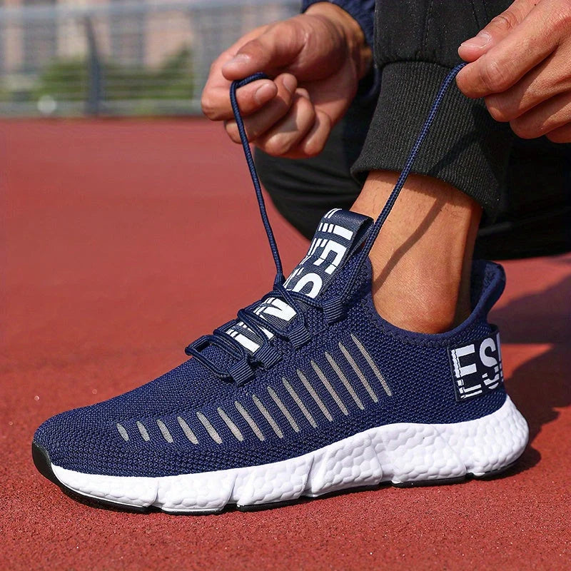 Men's knit trainers showing breathable mesh upper with ribbed texture and pull tab detail