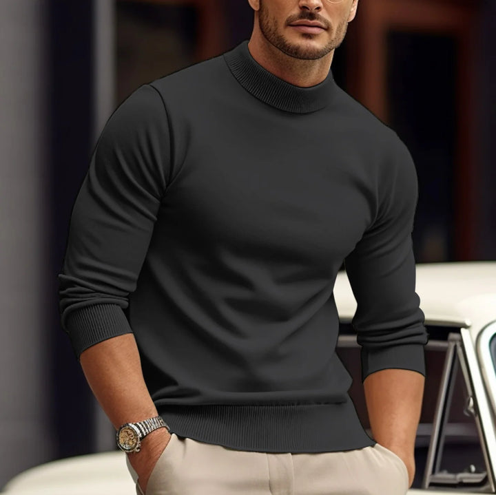 Close-up view of men's turtleneck jumper showing fine knit fabric texture and high ribbed collar detail