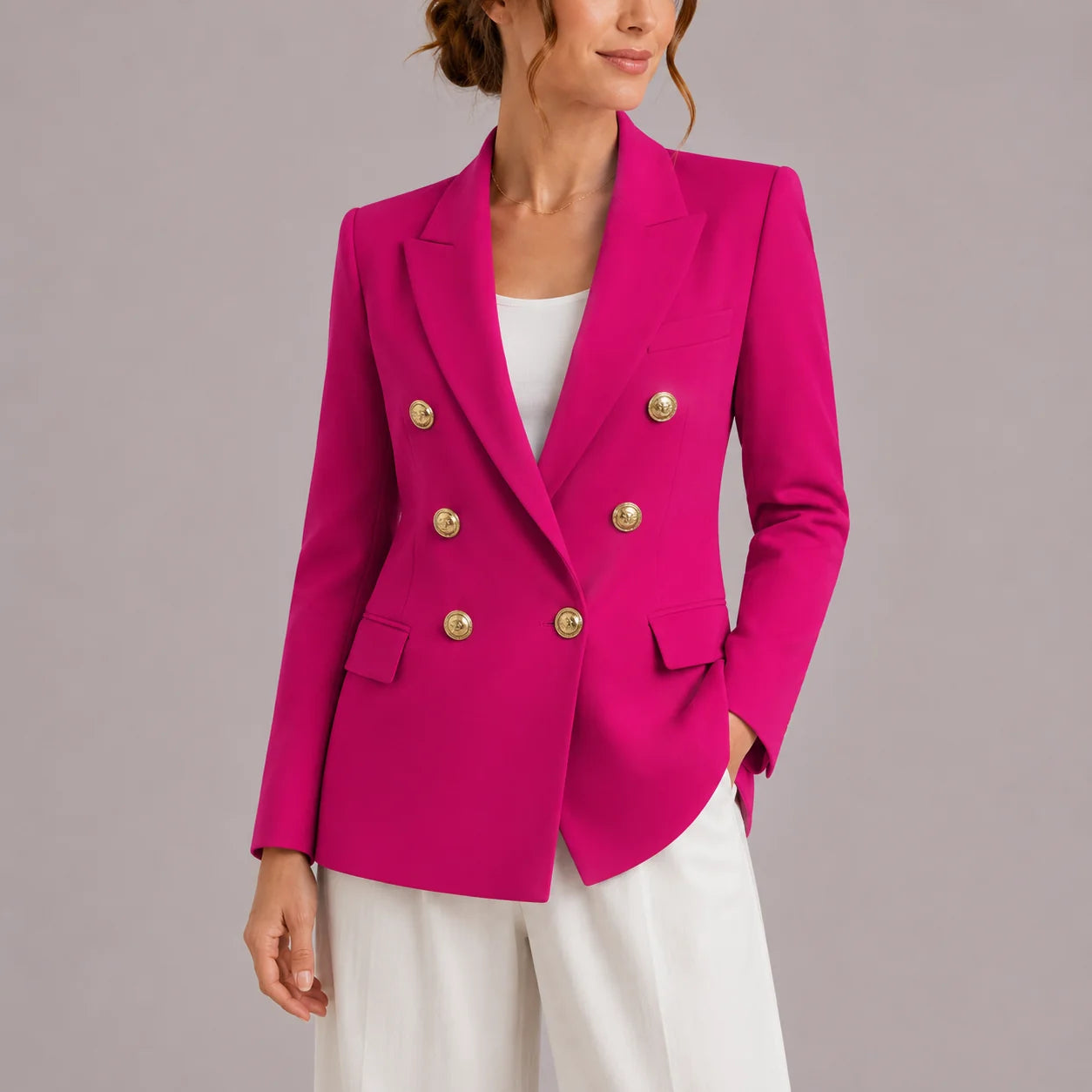 Women's black blazer styled with white trousers for smart-casual outfit
