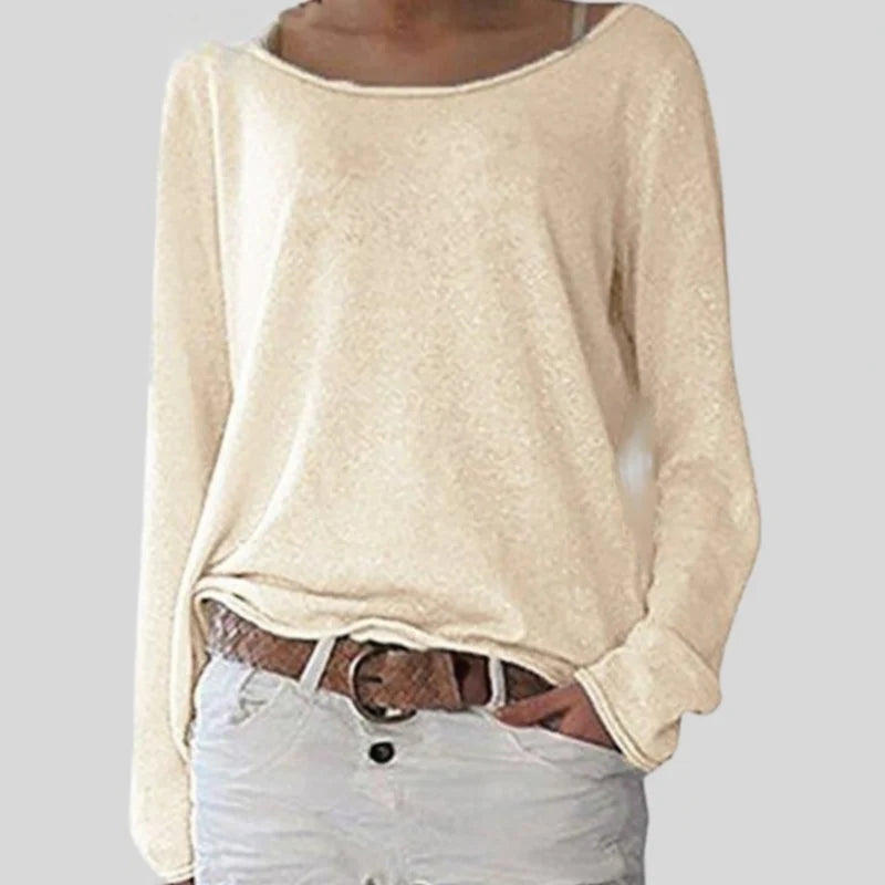Side view of women's knit long sleeve top with hip-length hem and finished cuffs