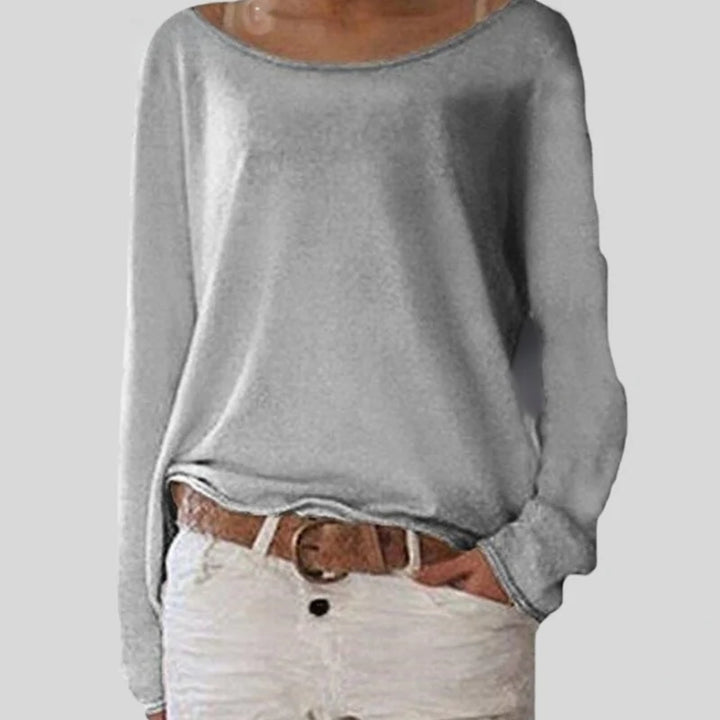 Women's knit long sleeve top styled with white trousers for casual everyday wear