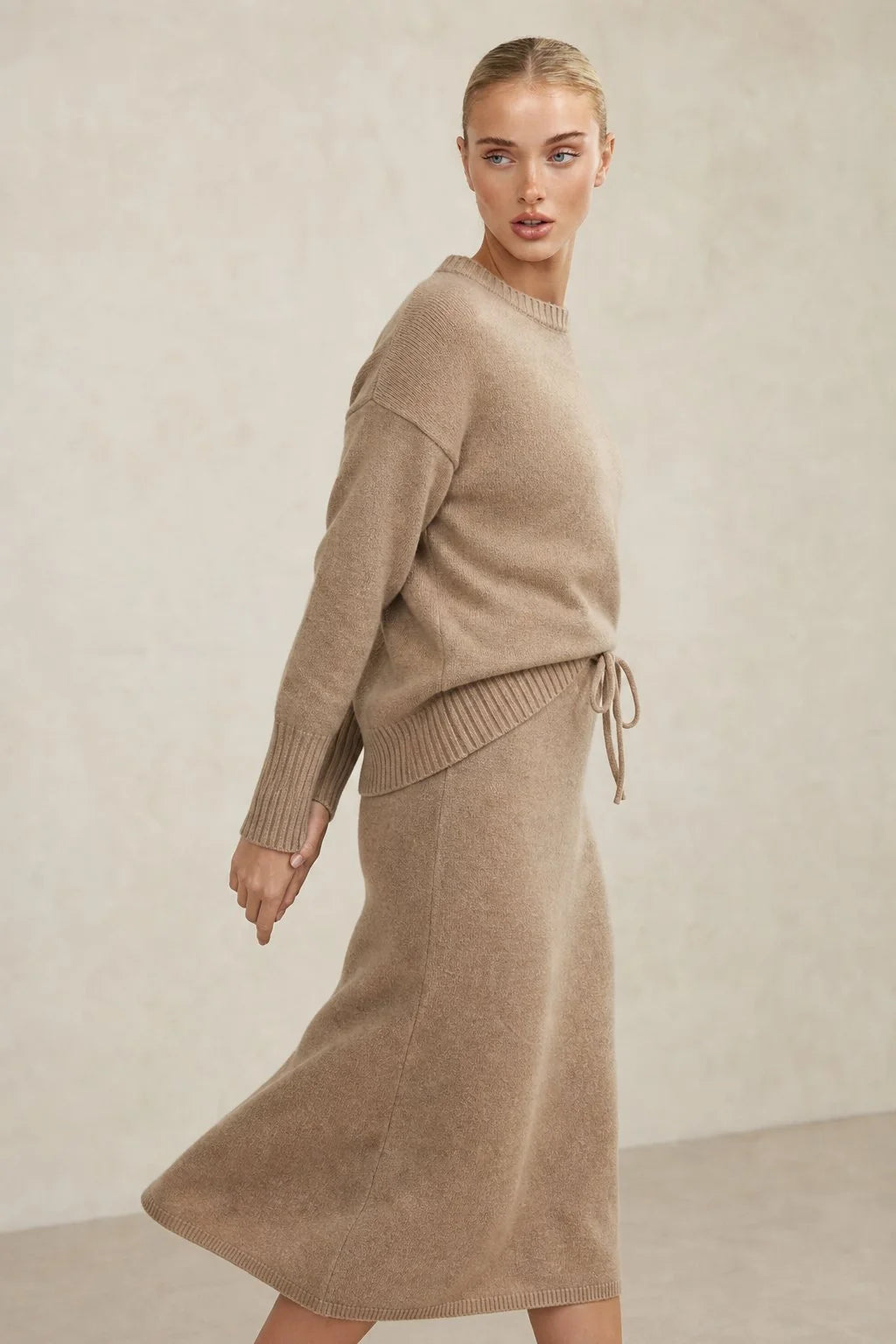 Women's knitted set in taupe featuring relaxed jumper with ribbed crew neck and matching midi skirt