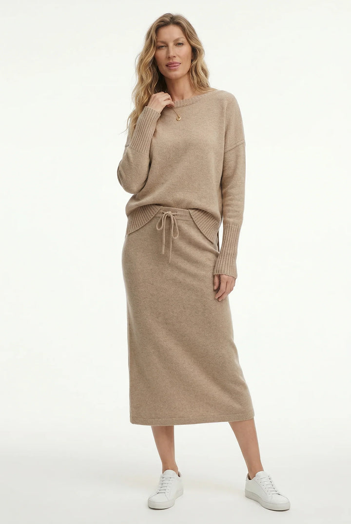 Back view of knitted set showing relaxed jumper fit and midi skirt length