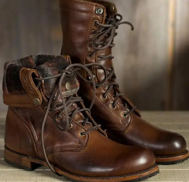 Close-up of women's mid-calf boots featuring metal eyelets and lace-up front closure detail