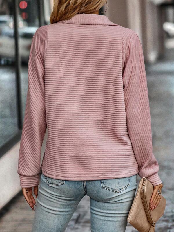 Close-up view of ribbed half zip jumper showing textured horizontal rib knit detail